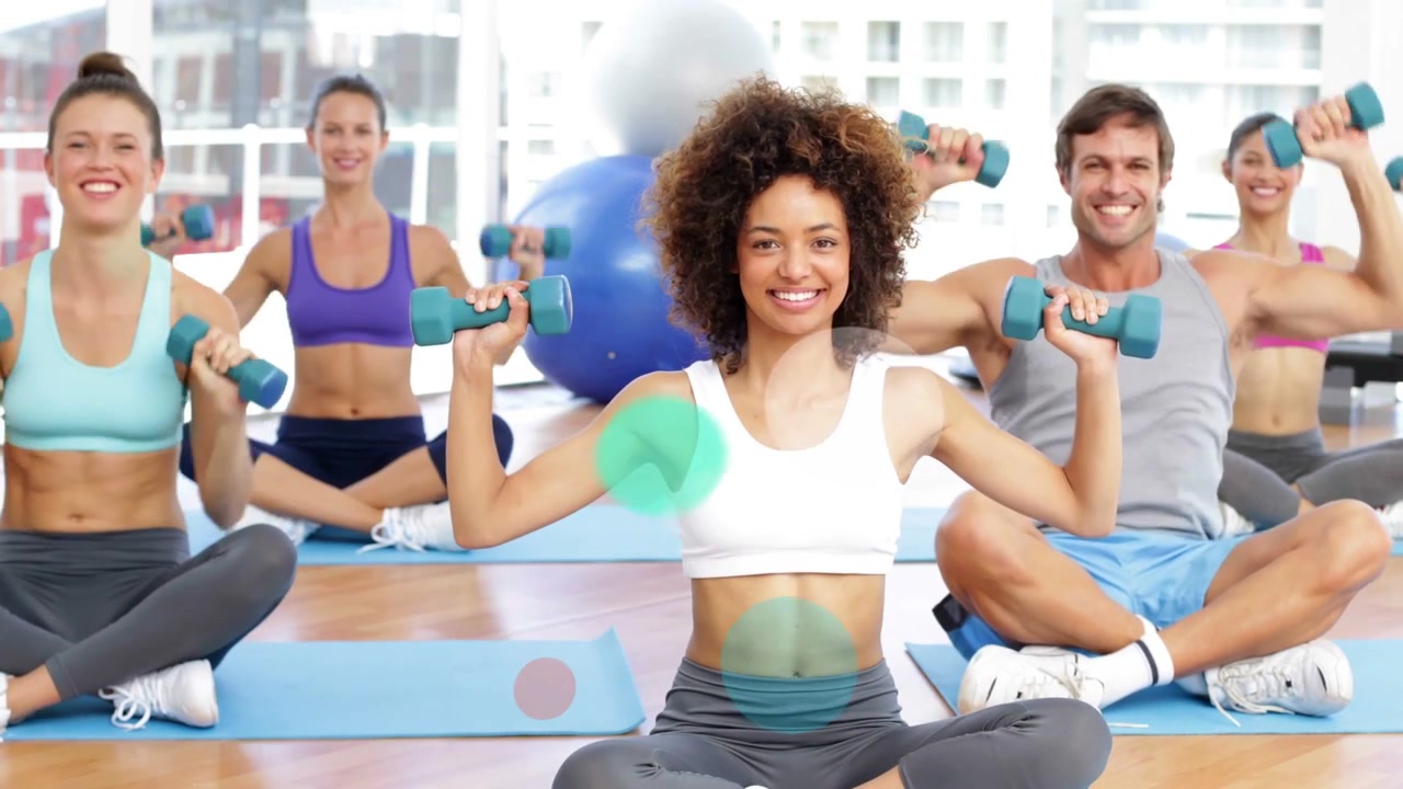Center woman raising arms causing color overlays while fitness class lifting teal weights on mats