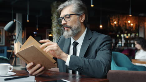 businessman reading in a cafe