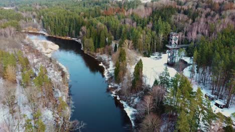 aerial view of anyksciai laju takas, treetop walking path complex with a walkway, an information center and observation tower, located in anyksciai, lithuania near sventoji river