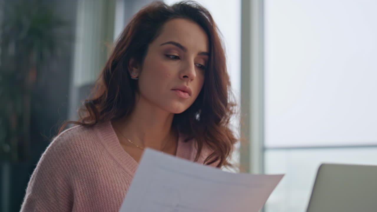Serious businesswoman reading document workplace closeup. Lady studying papers