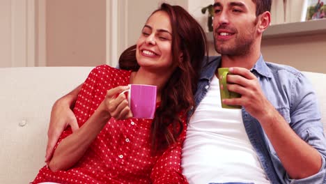 Happy-couple-drinking-hot-beverage-