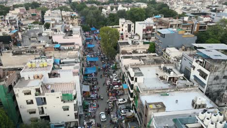 4k aerial shots of sunday market in new delhi residential suburbs on a beautiful day gliding over rooftops, streets, parks and markets in india