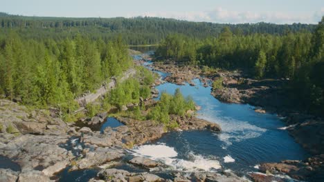 Flying-over-a-waterfall-and-rapids-during-a-warm-summer-night