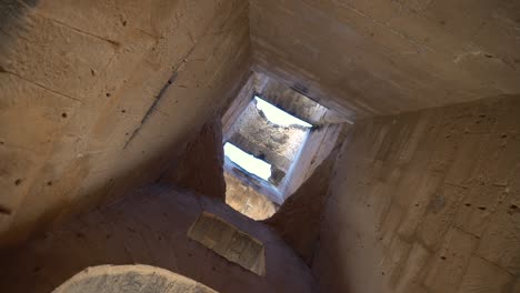 view inside the ruins ancient roman ruins . the camera is spinning from the bottom up. ancient roman ruins. ancient amphitheater located in el jem, tunis. historic landmark.