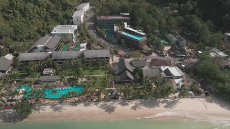 panoramic view of drone flying over the white sand beach with empty resorts due to pandemic travel restrictions