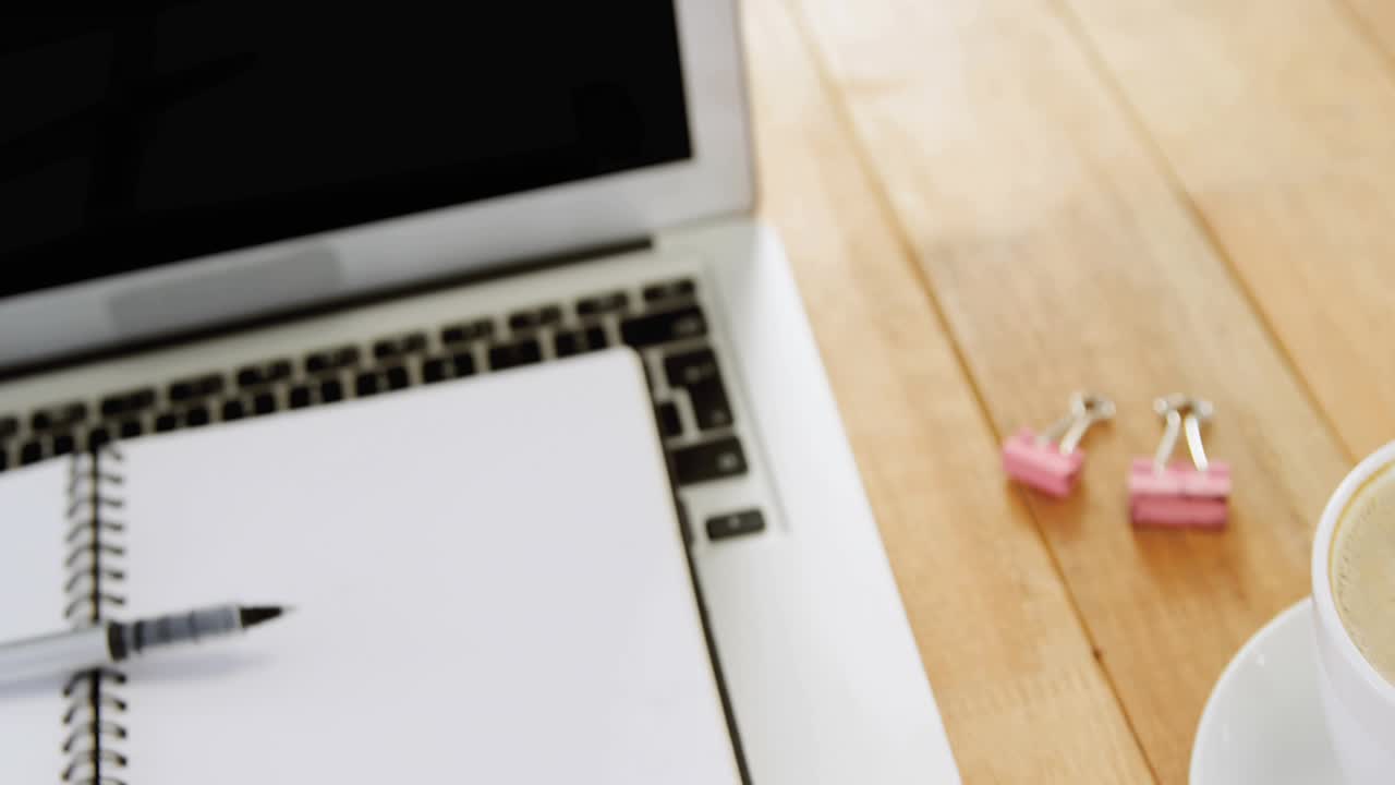 Code lines fading in over wooden desk setup while scrolling downward illustrating coding workflow