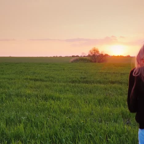 A-Young-Woman-With-Beautiful-Long-Hair-Runs-Along-The-Green-Field