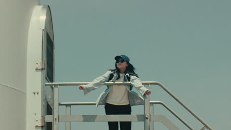 woman near wind turbine