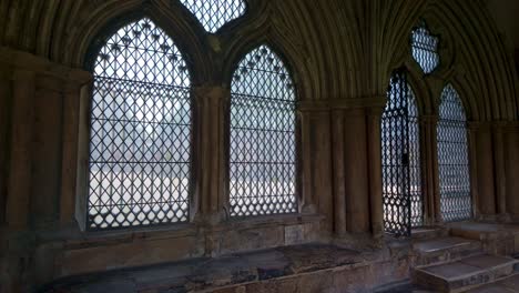 church interior with metal arch framed pattern windows in shadows