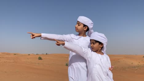 two arabic children in traditional dress looking long