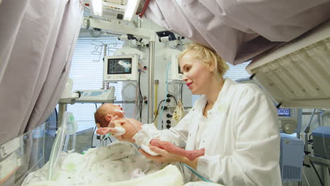 nurse caring for newborn infants in nicu