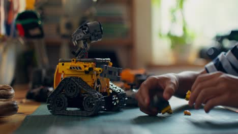 child building a lego wal-e robot