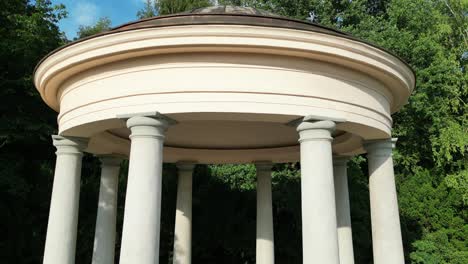 classical stone gazebo in a lush green park