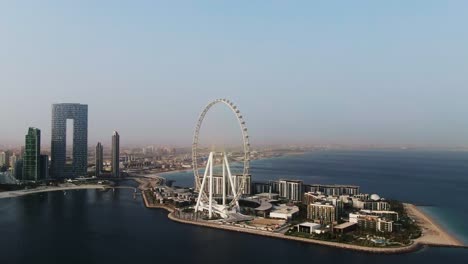 aerial view of ain dubai ferris wheel and dubai skyline