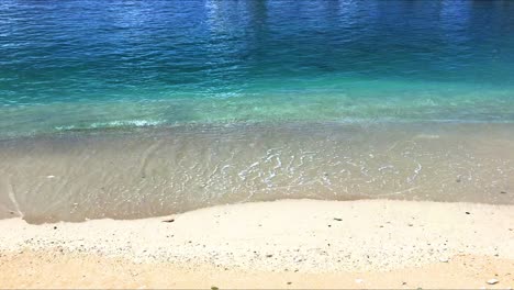 Waves-lapping-the-sandy-shoreline-of-this-peaceful-beach-in-slow-motion