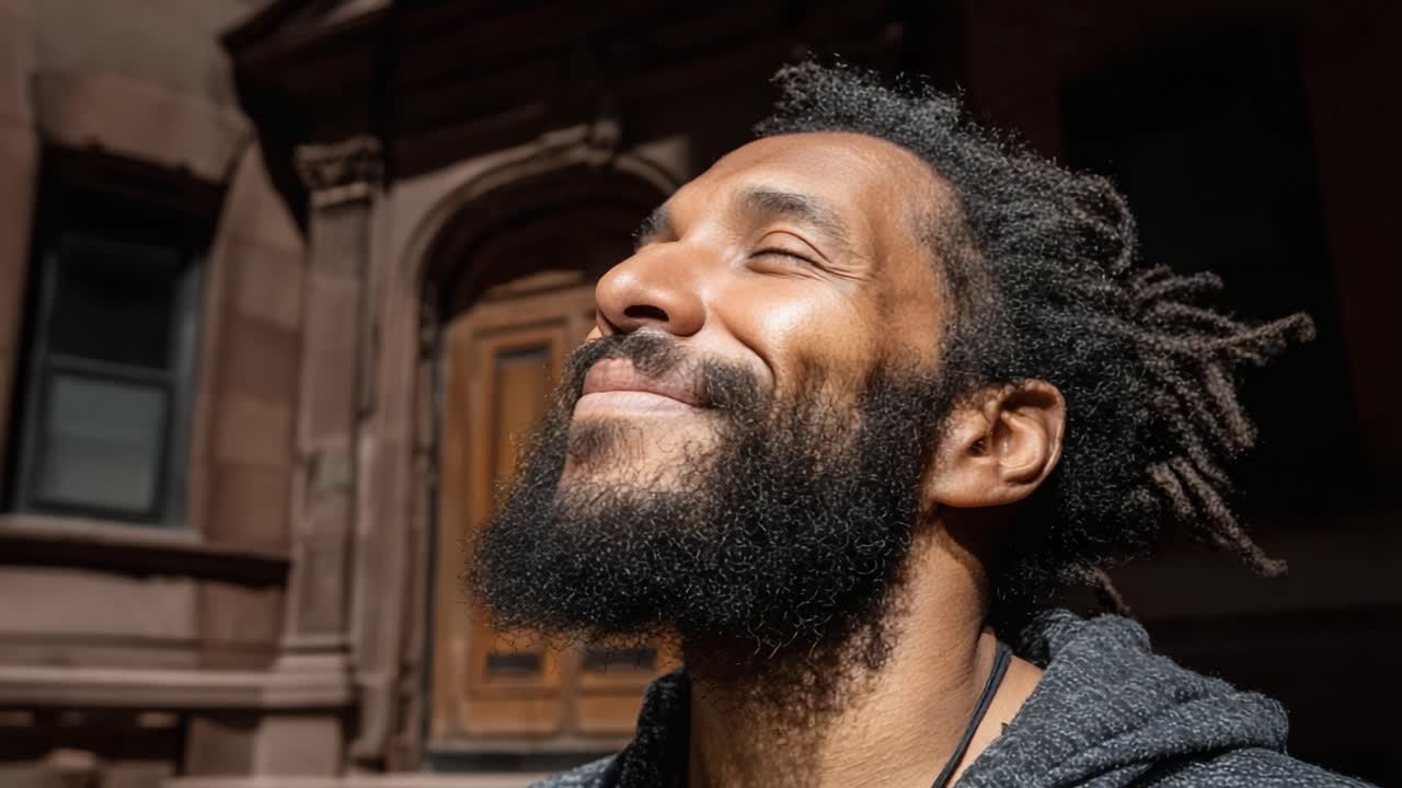 Joyful Moment of Reflection: A Man Enjoys the Warmth of the Sunlight, Embracing the Present in a Serene Urban Setting with a Contented Smile