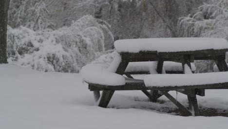 first snowfall on picnic table - slow motion