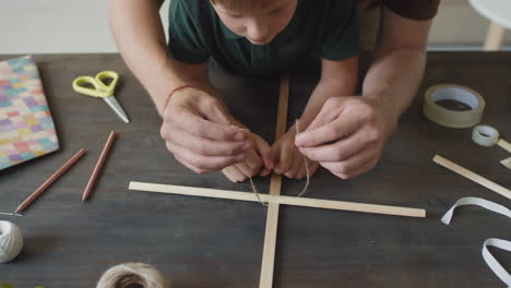 father and son creating a craft together