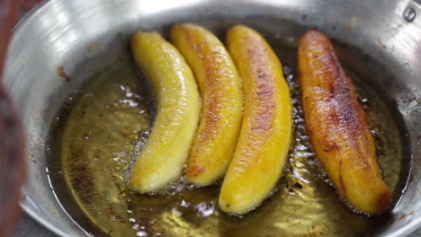 Close-Up-View-Of-Bananas-Being-Fried-In-Oil-Pan