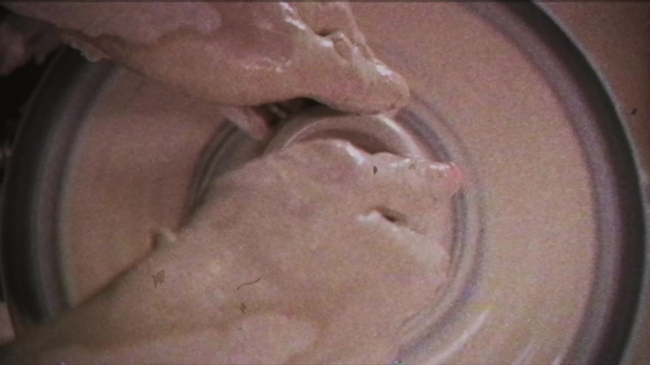 A potter teaches a woman to make clay dishes. A man takes a woman's hands. Vintage effect.