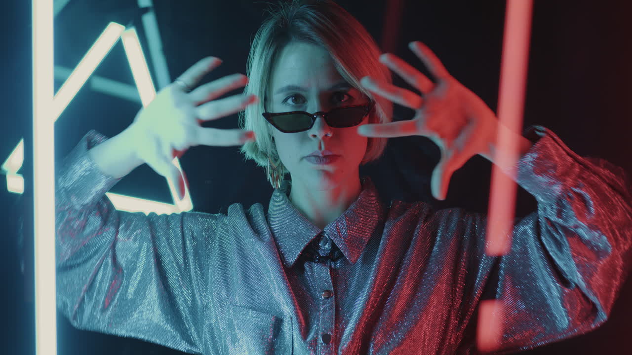Stylish woman posing in neon lights