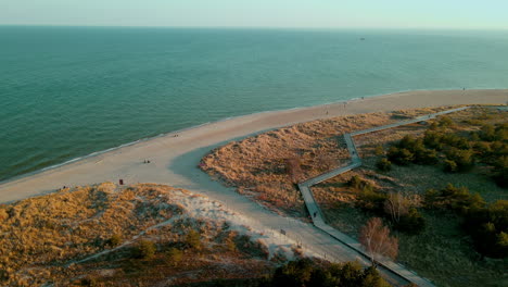 coastal boardwalk on sandy seashore in hel peninsula, puck bay, poland