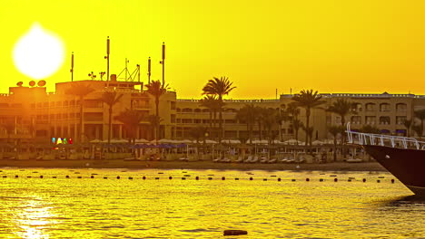 Touristic-beach-in-Hurghada,-Egypt-in-golden-sunset,-time-lapse