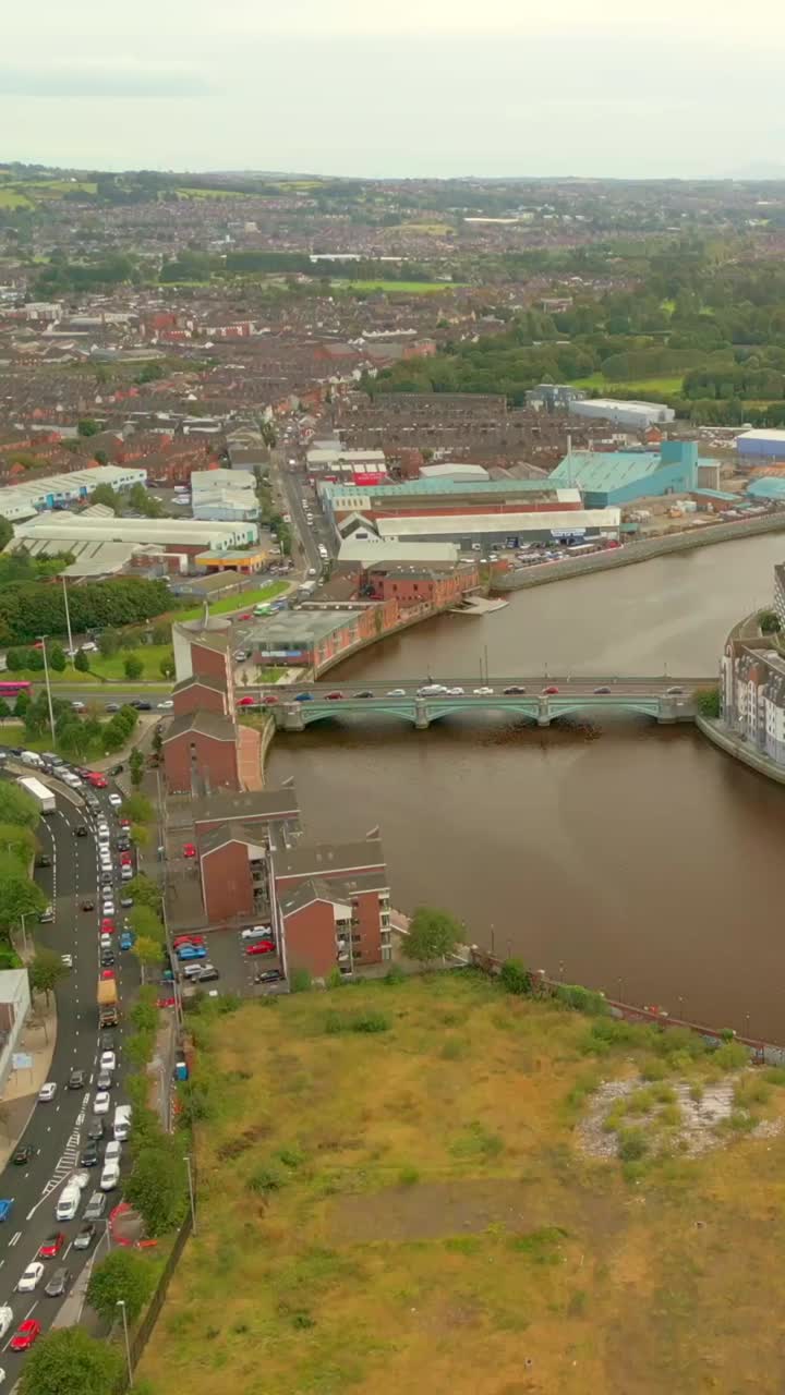 Reversing social ratio aerial video of the River Lagan and Belfast City centre on a sunny afternoon. Produced in 1080x1920, 60FPS and with Rec709 color
