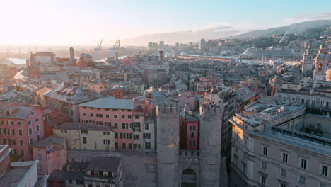 Aerial-sunset-push-in-toward-historic-Porta-Soprana-,-Genoa,-Italy