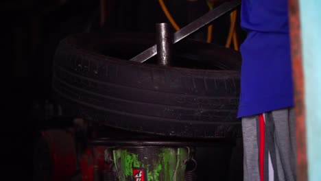 close up shot of the process of installing car tyre on rim