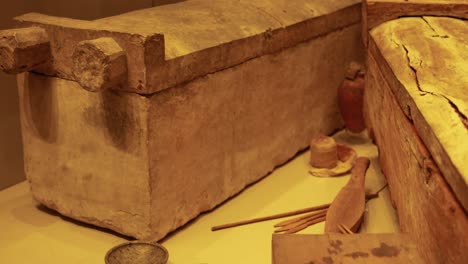 wooden coffin and artifacts in museum exhibit