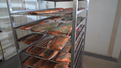 closeup to overview of trolley loaded with graved rainbow trout fillets