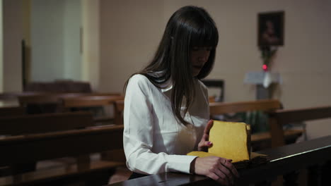 religious woman reading the bible in the church and praying
