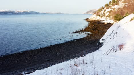 man admiring the scenery outside his tent in the coast in indre fosen, norway - aerial shot