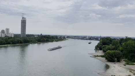 drone shot over the rhine with cargo ship ferrying on the river in germany