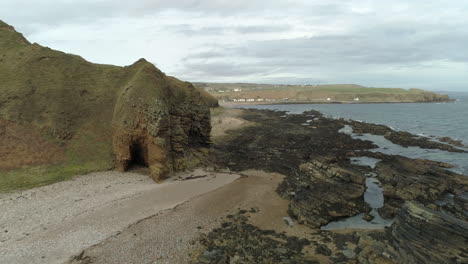 Aerial-view-across-the-rocky-coastal-area-heading-towards-Dunbeath,-Caithness,-Scotland