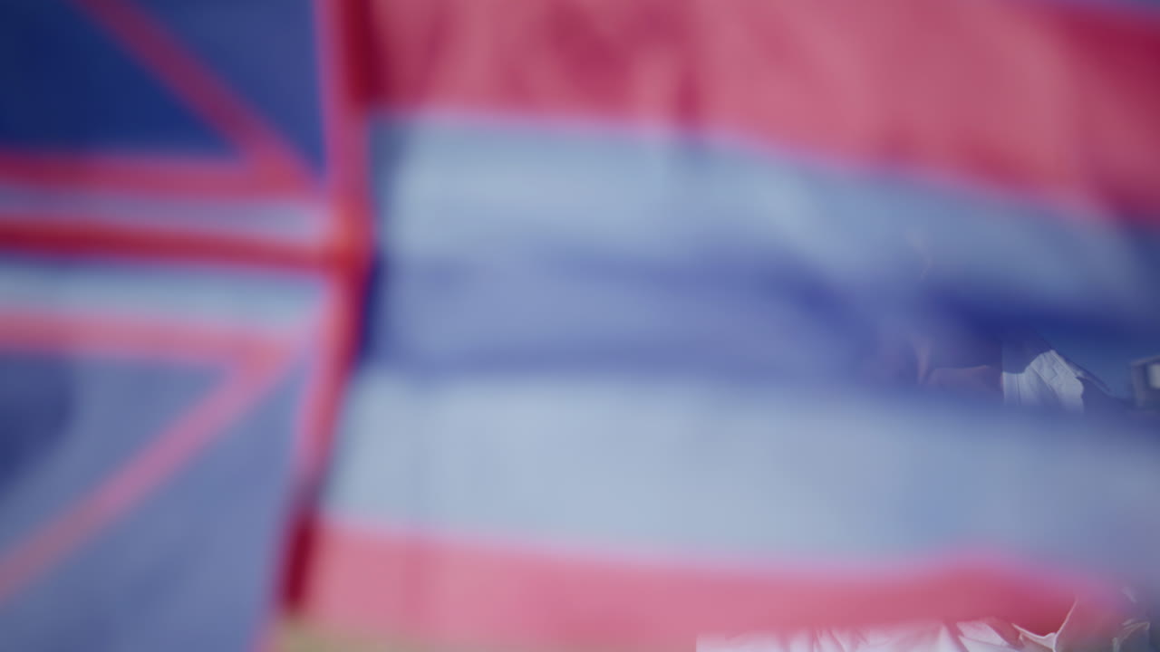 Smiling mom hugging child on sandy beach closeup. Mother holding flying kite