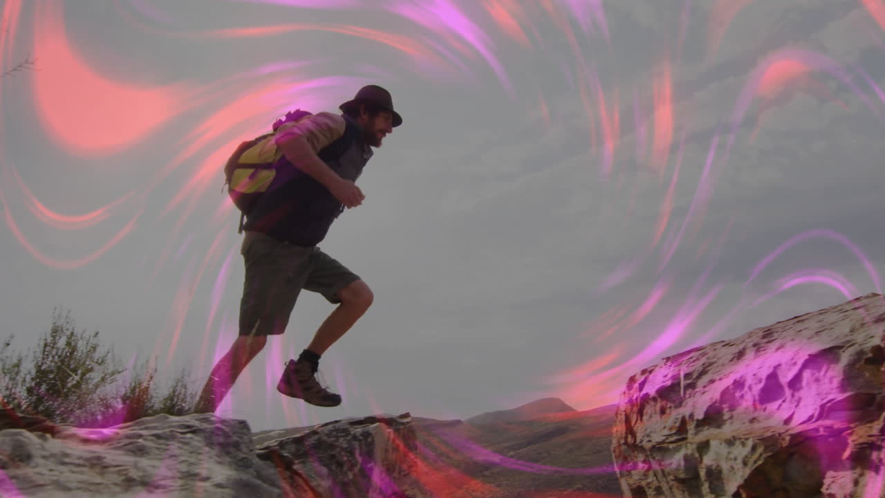 Male hiker stepping across rocky desert gap, with pink purple light overlays showing tech theme