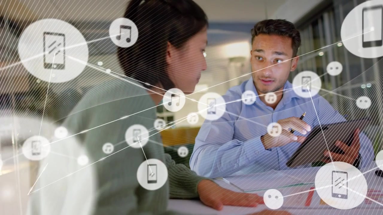 Colleagues reviewing charts while man pointing tablet starting icons appearing, showing network