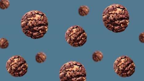 volando deliciosas galletas de chocolate de diferentes diámetros se mueven al centro en el fondo azul de tendencia (horizontal, no loopable) en imágenes de 4k uhd