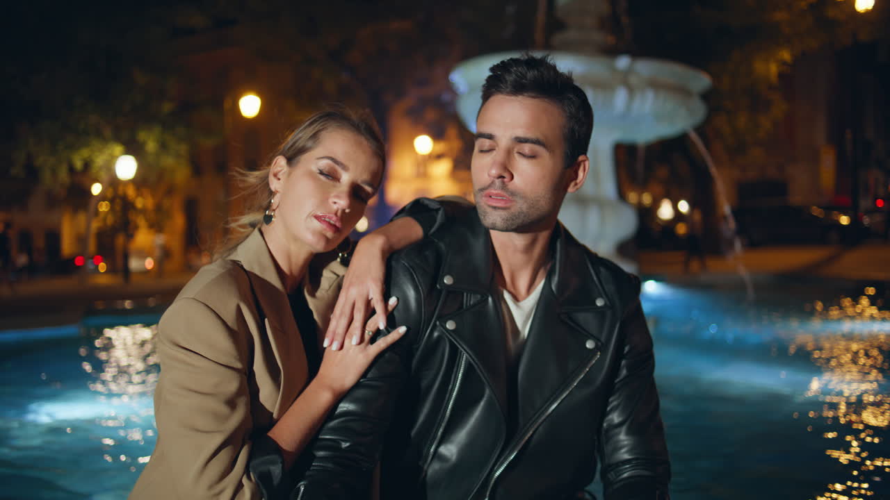 Portrait stylish pair together looking camera at night. Tourist couple resting