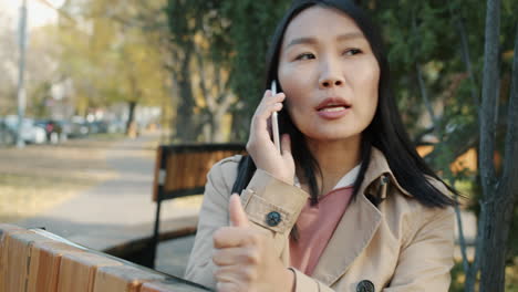 woman talking on phone in the park