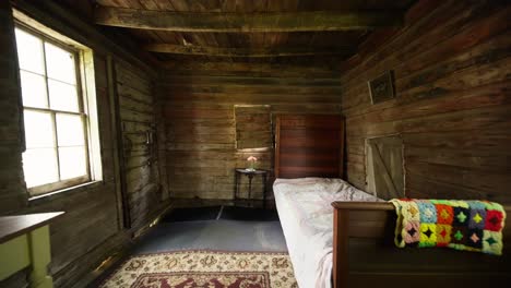 wide-push-in-shot-of-an-old-style-bedroom-with-all-wood-finishes-including-a-twin-bed-and-a-desk