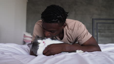 pet owner with his cat on bed