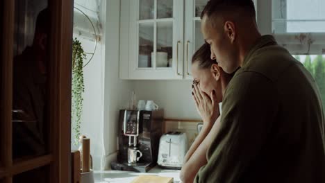 couple hugging in kitchen