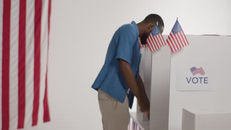 voters in booths with ballot papers casting votes in american election 1