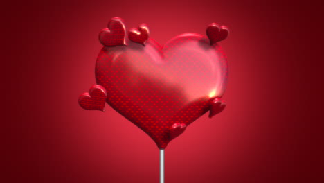 corazón de san valentín de caramelo y corazones pequeños en degradado rojo
