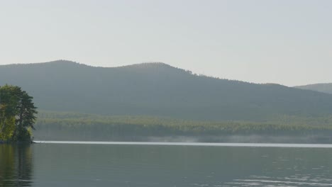 misty morning/evening by the lake with mountains