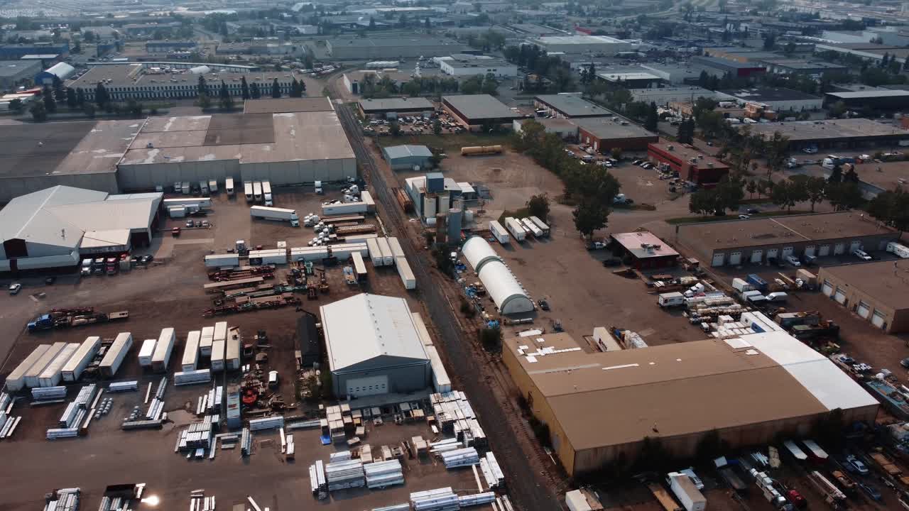 Aerial orbiting shot in an industrial area with trucks and warehouses in Calgary, Alberta