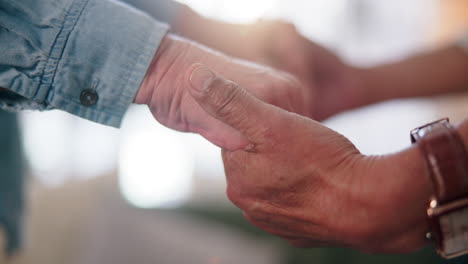 elderly couple holding hands